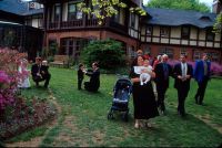 Guests arrive at the wedding site behind the mansion